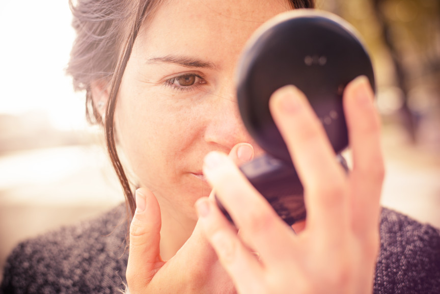 woman with compact mirror