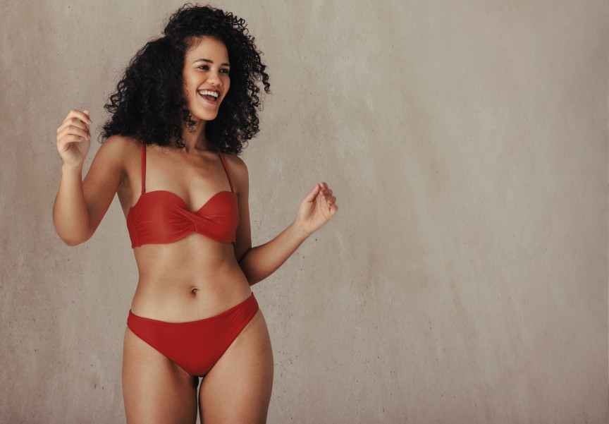 woman in red bikini with dark curly hair