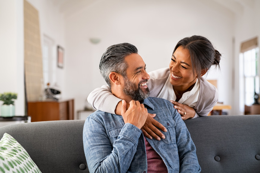 smiling mature couple in living room