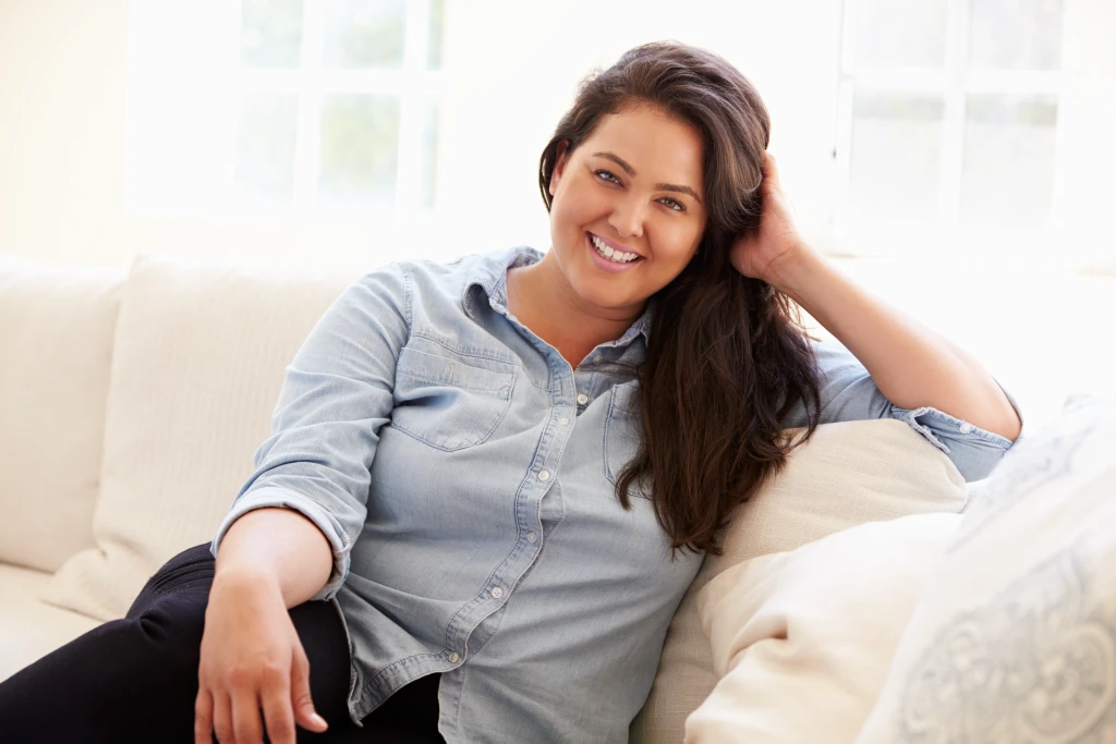 smiling woman sitting on couch