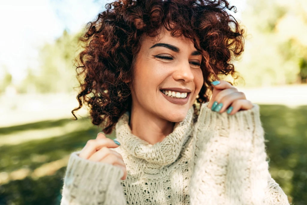 Smiling female outside in the shaded grass