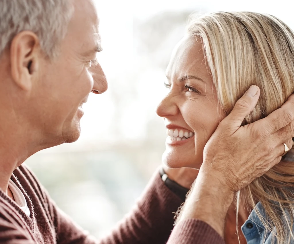 Man holding woman's head